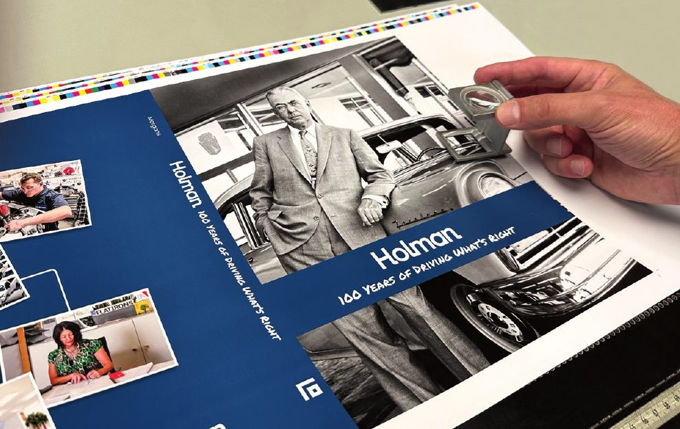 Holman 100 Years press sheet being checked by hand